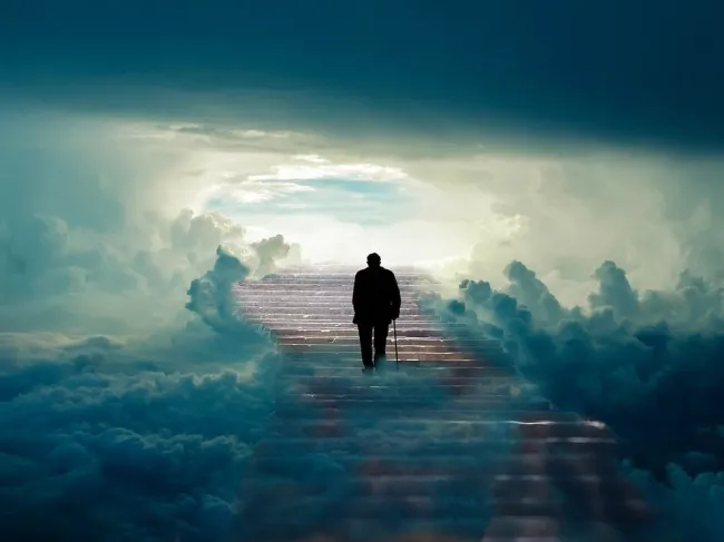 Man walking up stairs with clouds around him